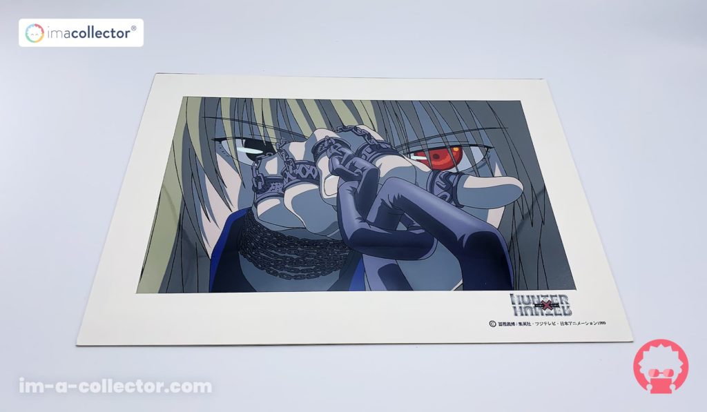 Rilezu officiel de Kurapika aux yeux écarlates, avec chaînes au premier plan, issu de l’anime Hunter × Hunter de 1999.